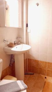 a bathroom with a white sink and a shower at Creta Spirit in Plakias