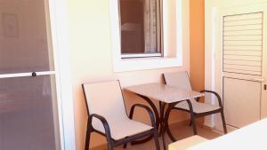 a small table and chairs in a room with a window at Creta Spirit in Plakias