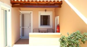 an open door of a house with a table at Creta Spirit in Plakias