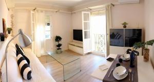 a living room with a couch and a glass table at Sopranis by Gades Gestión in Cádiz