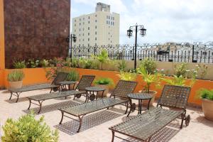 a group of chairs and tables on a patio at Hotel Colonial de Merida in Mérida +30 photos