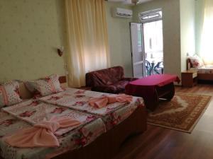 a bedroom with a bed and a couch and a table at Anele,Kiten in Kiten