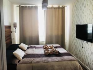 a bedroom with a bed with towels on it at Jenys Apartment in Teplice