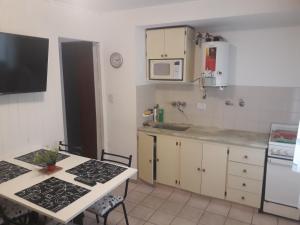 a small kitchen with a table and a microwave at Departamento ideal I! in Villa María