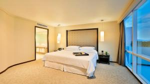a bedroom with a large bed and a large window at Barceló Mexico Reforma in Mexico City