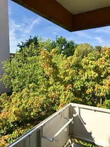 a view of some trees from a balcony at Big Dream in Hannover