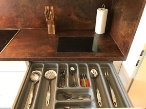 a kitchen counter with a sink with utensils at Big Dream in Hannover