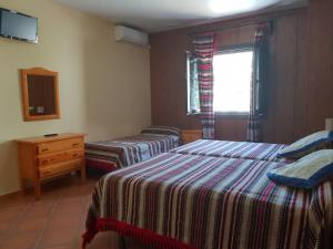 Postel nebo postele na pokoji v ubytování Hostal Pampaneira