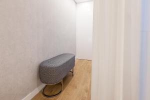 a chair sitting in a corner of a room at Art's Braga Studio - Minho's Guest in Braga