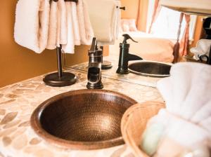a bathroom counter with a sink and two sinks at The Bevin House B&B in East Hampton