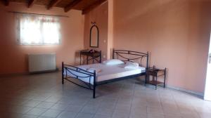 a bedroom with a bed and two night stands at Rania Studios in Lefkada +25 photos