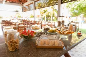 a table with a buffet of food on it at Pousada Recanto do Prado in Prado