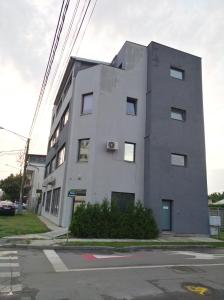 a tall white building on the corner of a street at Colosseum Residence in Bucharest