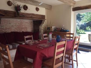 a dining room with a table and chairs and a fireplace at Domaine de Marsaguettes in Morlhon-le-Haut +10 photos