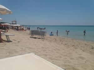 a group of people playing in the water at the beach at Appartamento al mare Puglia in Ginosa Marina