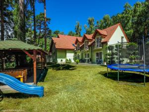 a yard with a house and a playground at Wachta Pobierowo in Pobierowo