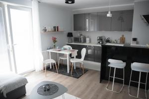 a kitchen with a table and chairs in a room at Apartament Soft 11 in Biała Podlaska