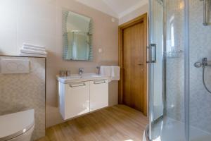 a bathroom with a toilet and a sink and a shower at Two-Bedroom Apartment in Crikvenica XXXIV in Dramalj