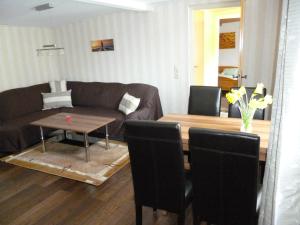 a living room with a couch and a table at Haus Frohsinn in Ueckeritz