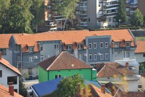 a group of houses with roofs in a city at Villa Grazia in Vladičin Han
