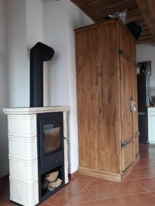 a room with a stove and a wooden cabinet at Apartmány Hradiště in Znojmo
