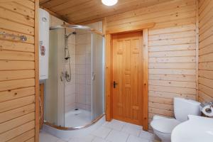 a bathroom with a shower and a toilet and a sink at Hotel "Odessa" in Verkhovyna +11 photos