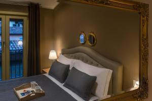a bedroom with a large mirror above a bed at 051 Boutique in Bologna