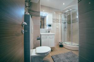 a bathroom with a toilet and a sink and a shower at Apartmani Josip in Podstrana +45 photos