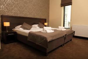 Łóżko lub łóżka w pokoju w obiekcie Hotel Forum Fitness Spa & Wellness