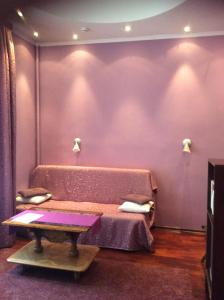 a purple room with a table and a purple wall at Pushkin Square in Saint Petersburg
