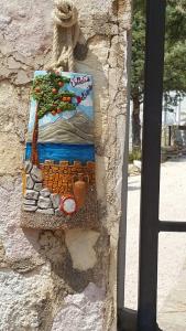 a painting of a tree on the side of a building at Villetta Delizia in Scopello