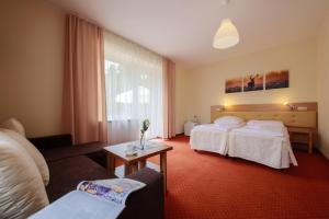 Łóżko lub łóżka w pokoju w obiekcie Hotel Łaziska