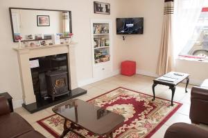 a living room with a couch and a fireplace at Sive Budget Accommodation in Cahersiveen