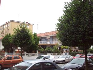 a group of cars parked in front of a building at Pensión Los Pinos Gijón in Gijón +17 photos