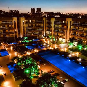 a view of a large building with a pool at night at V G Fun Praia Do Futuro in Fortaleza