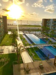a view of a swimming pool next to the beach at V G Fun Praia Do Futuro in Fortaleza