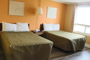 Katil atau katil-katil dalam bilik di Travellers Inn