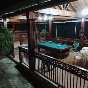 a pool table on the balcony of a house at Finca Sanfelipe in Calima