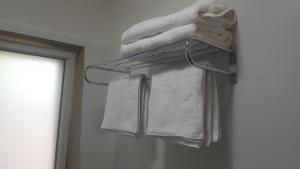 a towel rack with towels on it in a bathroom at Engel apartments -אירוח למטיילים בגליל עליון in Tsiv'on +14 photos