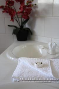 a white towel sitting on top of a white sink at Illawong Beach Resort in Mackay
