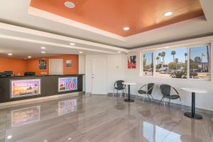 a lobby with chairs and tables in a building at Motel 6-South El Monte, CA - Los Angeles in South El Monte