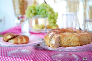 a table with two plates of pastries and grapes at Casa Baia Luna in Ponza