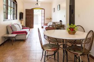 a living room with a table and chairs and a couch at Bertioga Beach Hostel in Bertioga
