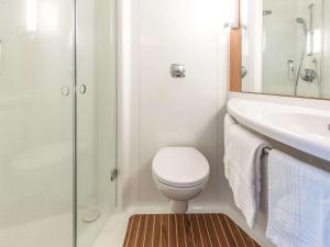 a bathroom with a toilet and a sink and a shower at ibis Issoire in Issoire