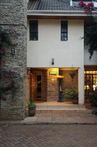 un edificio in mattoni con una porta e piante di fronte di Hob House a Nairobi