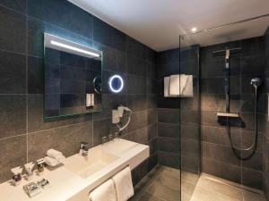 a bathroom with a sink and a shower at Mercure Amsterdam Sloterdijk Station in Amsterdam
