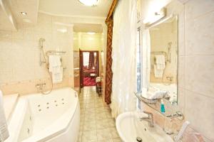 ein Badezimmer mit einer Badewanne, einem Waschbecken und einer Badewanne in der Unterkunft Boutique Hotel Monte Kristo in Riga