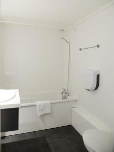 a white bathroom with a sink and a toilet at Aerel Hotel Aéroport Blagnac in Blagnac