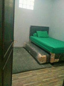 a bedroom with a bed made out of a log at Homestay Bumi Asri III Cikutra in Bandung