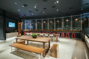 a dining room with tables and chairs and a bar at The Bed KLCC in Kuala Lumpur